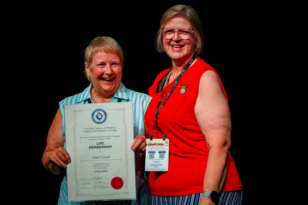 Anne Connell holding her Life Membership certificate, with ASMIRT President, Carolyn Heyes, standing beside her.
