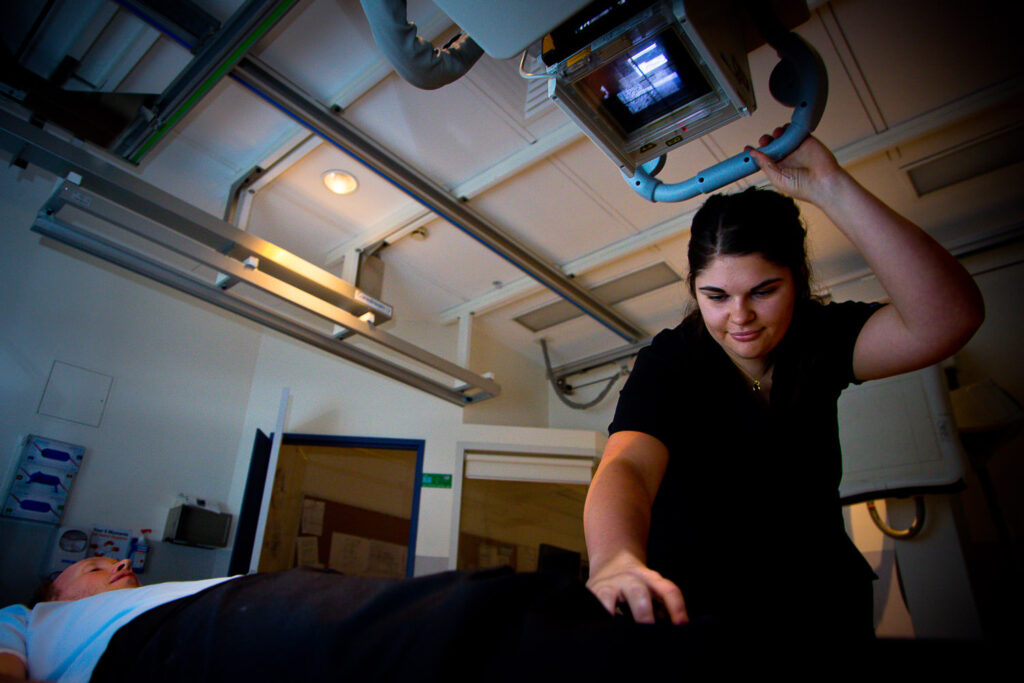 A young radiographer takes an X-ray.